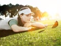 Young Female Golfer Looking at Ball on tee Royalty Free Stock Photo