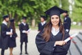 A young female graduate against the background of university graduates. Royalty Free Stock Photo