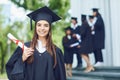 A young female graduate against the background of university graduates. Royalty Free Stock Photo