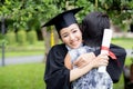 Young female graduate hugging her friend at graduation ceremony Royalty Free Stock Photo