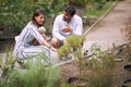 Young female guide giving informations about plants to a visitor