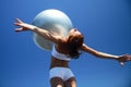 Young female gymnast with yoga ball on her chest Royalty Free Stock Photo