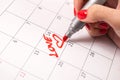 Heartfelt Calendar: Young Female Hand Drawing Hearts and Words in Reminder for Valentine\'s Day (Close-Up) Royalty Free Stock Photo