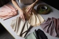 Young female hands with fabric samples for curtain concept of Interior design, created with Generative AI technology