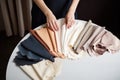 Young female hands with fabric samples for curtain concept of Interior design, created with Generative AI technology