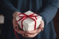 Young female hands holding gift box with red ribbon Royalty Free Stock Photo