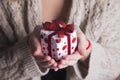 Young female hands holding single gift box