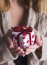 Young female hands holding single gift box