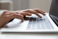 Young female hands typing on keyboard of modern laptop computer Royalty Free Stock Photo