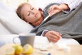 Young female having flu laying in bed Royalty Free Stock Photo