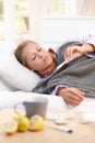 Young female having flu laying in bed Royalty Free Stock Photo