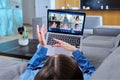 Young female having video conference with group of teenage students on laptop Royalty Free Stock Photo