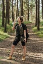 Female hiker drinking water from reusable bottle in green forest