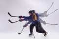 Young female hockey player with the stick on ice court and white background, action and motion concept Royalty Free Stock Photo