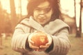 Young female holding apple with I love you inscription in the park Royalty Free Stock Photo