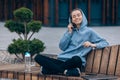 Young female in hood listening to music with closed eyes. Royalty Free Stock Photo