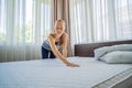 Young Female Housekeeper Changing Bedding In Hotel Room Royalty Free Stock Photo