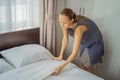 Young Female Housekeeper Changing Bedding In Hotel Room Royalty Free Stock Photo