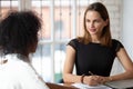 Young female hr manager holding job interview with african candidate. Royalty Free Stock Photo