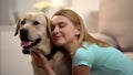 Young female hugging adorable labrador dog, housepet, best friend concept