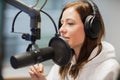 Radio Jockey Looking Away While Using Headphones And Microphone