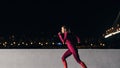 Young female jogger exercising in the evening. Woman running at embankment