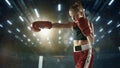 Young female kickboxing fighter training in the gym