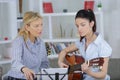 Young female learning to play guitar