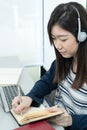 Young female long hair sitting in living room and learning online Royalty Free Stock Photo