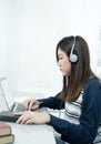 Young female long hair sitting in living room and learning online Royalty Free Stock Photo