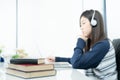 Young female long hair sitting in living room and learning online Royalty Free Stock Photo