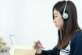 Young female long hair sitting in living room and learning online Royalty Free Stock Photo