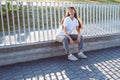 Young female with long wears hair white t-shirt.