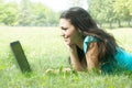 Young female lying on the grass using a laptop Royalty Free Stock Photo
