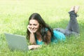 Young female lying on the grass using a laptop Royalty Free Stock Photo