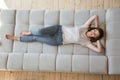 Young female lying on sofa at home