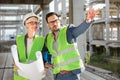 Young female and male engineers or business partners at construction site Royalty Free Stock Photo