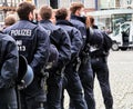 Young female and male police officers standing behind each other in a row Royalty Free Stock Photo