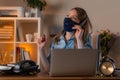 Young female manager in face mask working in the office, talking on the phone. Healthcare and protection concept. Work during a