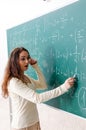 The young female math teacher in front of chalkboard Royalty Free Stock Photo