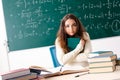 The young female math teacher in front of chalkboard Royalty Free Stock Photo