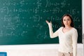 The young female math teacher in front of chalkboard Royalty Free Stock Photo