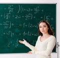 Young female math teacher in front of chalkboard Royalty Free Stock Photo