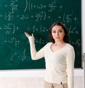 Young female math teacher in front of chalkboard Royalty Free Stock Photo