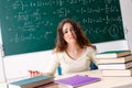 The young female math teacher in front of chalkboard Royalty Free Stock Photo