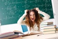 The young female math teacher in front of chalkboard