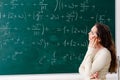 The young female math teacher in front of chalkboard Royalty Free Stock Photo