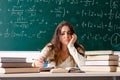 Young female math teacher in front of chalkboard