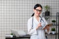 Young female medical nurse using tablet computer in hospital office Royalty Free Stock Photo