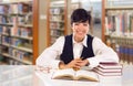 Young Mixed Race Student In Library with Books, Paper and Glasses Royalty Free Stock Photo